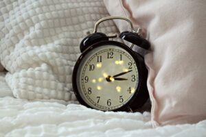 Alarm clock in bed linen