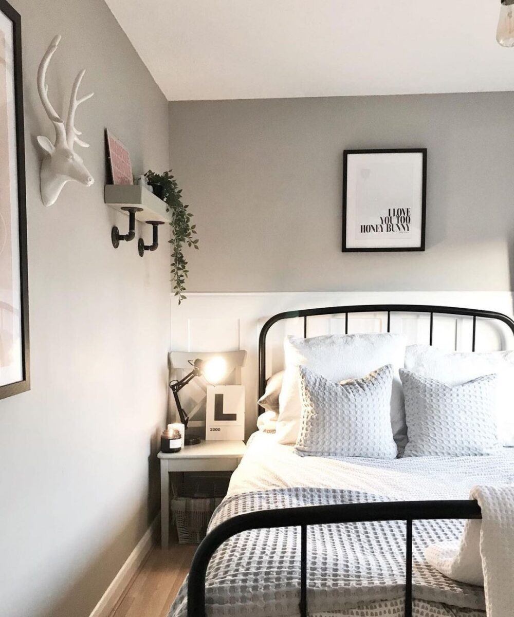 Black metal bed frame against white walls